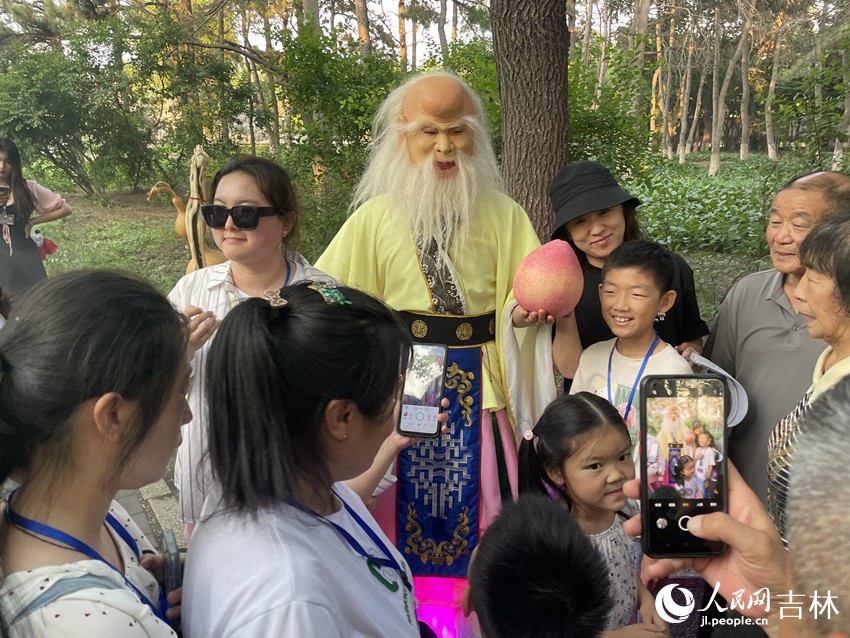 手拿寿桃的寿星引得众人围观。人民网记者 李思玥摄