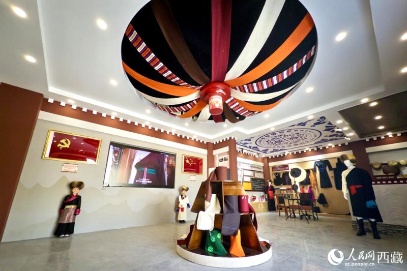图为克西氆氇文化传承馆内部，穹顶设计色彩斑斓，展陈着精美的传统服饰与文创产品。人民网记者 次仁罗布摄